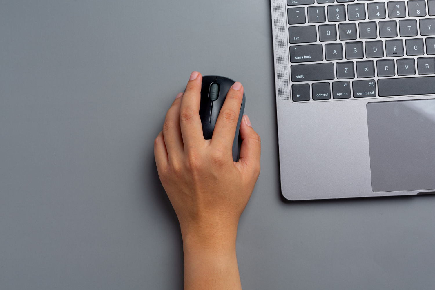 woman-works-with-laptop-home-holds-computer-mouse-her-left-hand